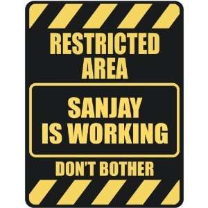   RESTRICTED AREA SANJAY IS WORKING  PARKING SIGN