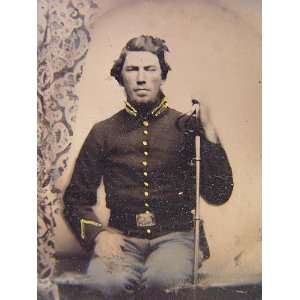   soldier in Union cavalry uniform sitting with saber