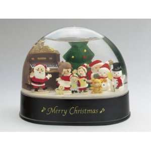 Close Up of a Figurine of a Santa Claus with a Family in a Snow Globe 