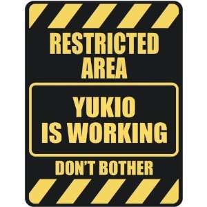   RESTRICTED AREA YUKIO IS WORKING  PARKING SIGN