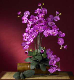 Vibrant silk orchid flower arrangement dresses up table