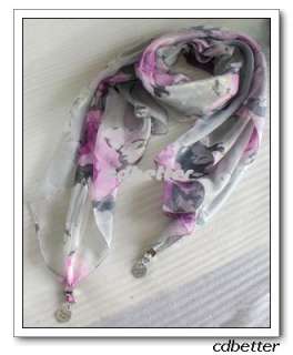 Long scarf with lovely round metal pendant.