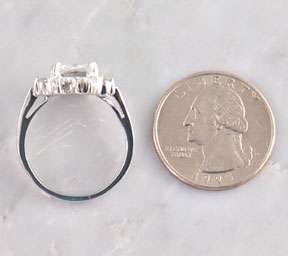   Ring is a Square Princess Cut & small round CZ stones around the ring