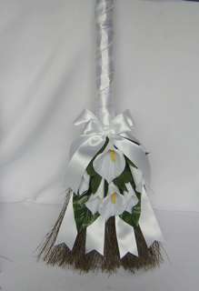 The beautiful handcrafted wedding broom is wrapped in satin ribbon and 