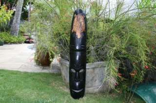 here is a wooden fijian mask featuring a hand carved turtle 